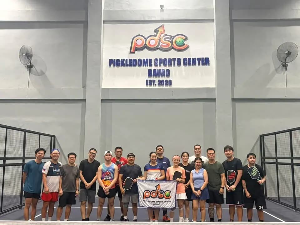 Pickledome Sports Center players holding a club banner