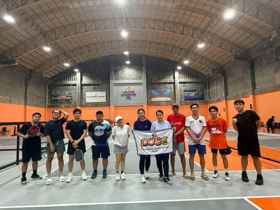 Pickledome Sports Center players together on an indoor court